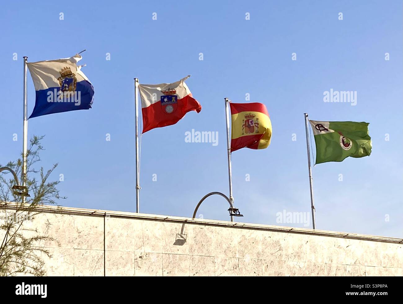 Flags of Santander Cantabria Spain and Racing Santander football club on a windy day on the roof of a restaurant Sardinero Santander Cantabria Spain - Smartphone Captured Stock Image