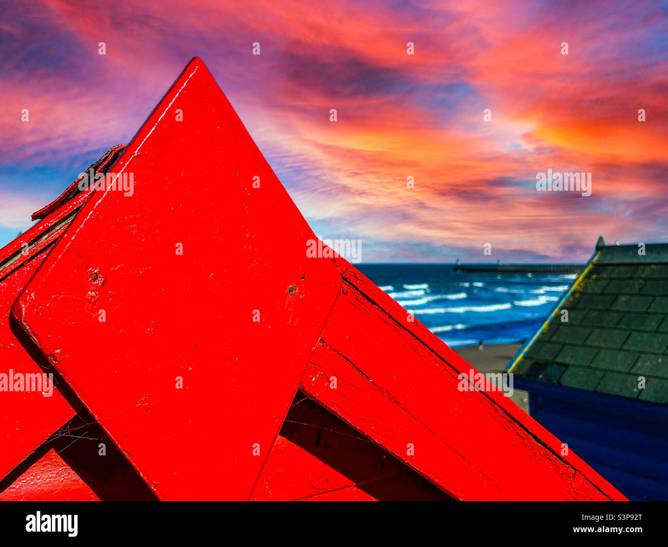 Close up of a red luxury beach chalet overlooking the North Sea in Whitby North Yorkshire - Smartphone Captured Stock Image