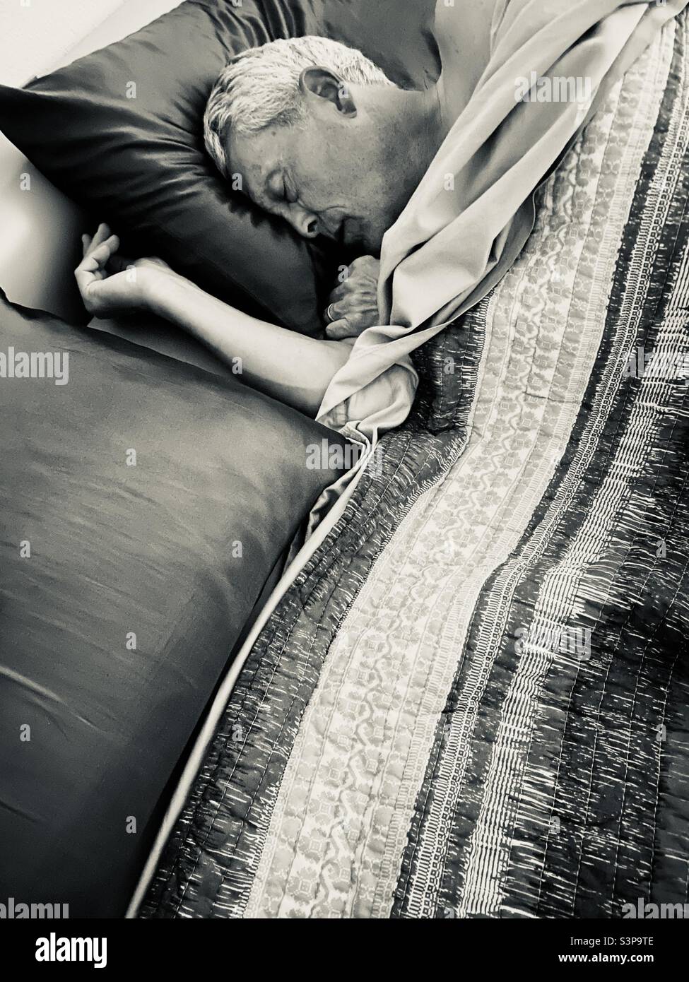 Older man comfortably asleep in his bed. - Smartphone Captured Stock Image