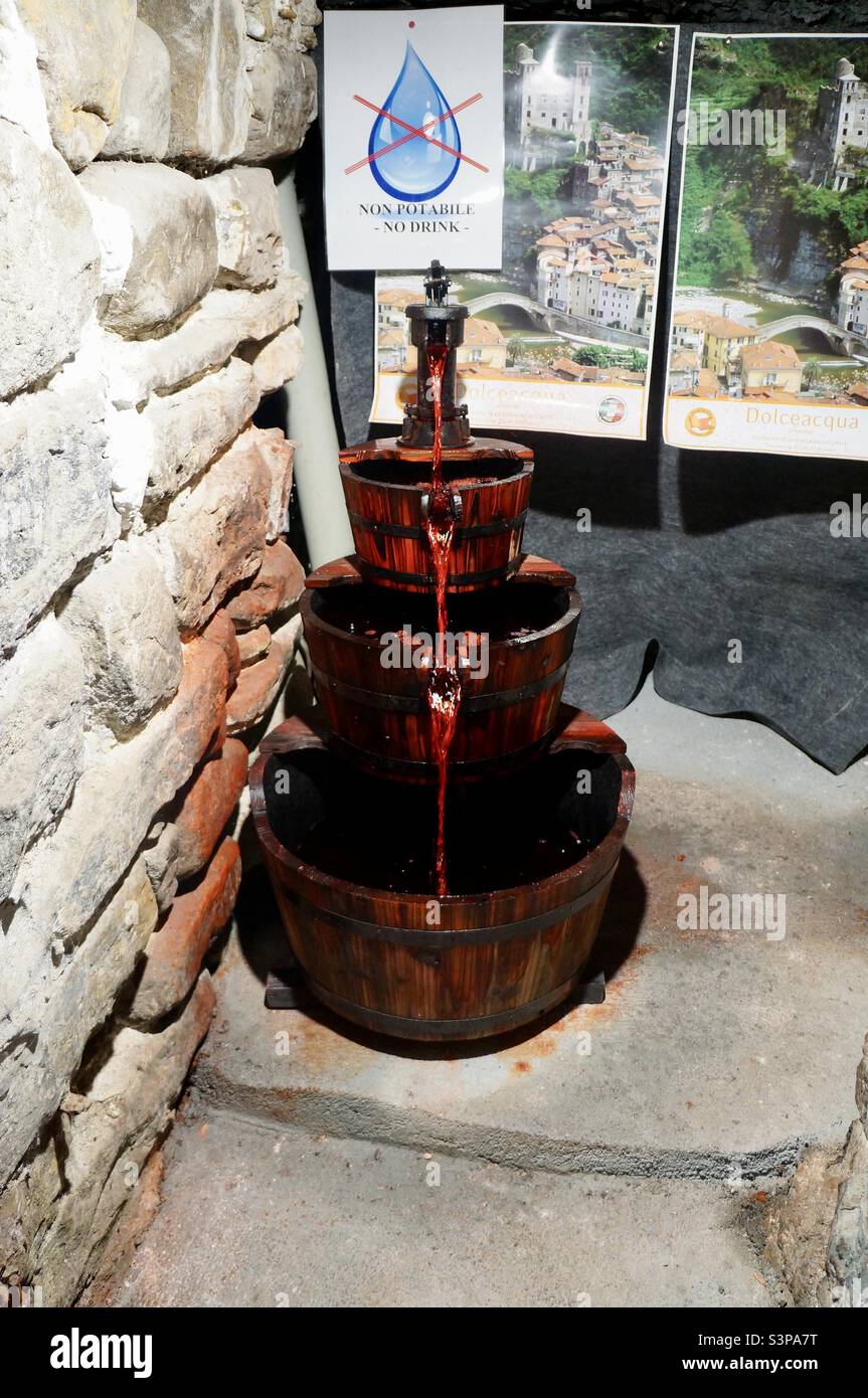 This artistic fountain from which red colored water flows was created to represent the famous Rossese wine making of the region of Dolceacqua. - Smartphone Captured Stock Image