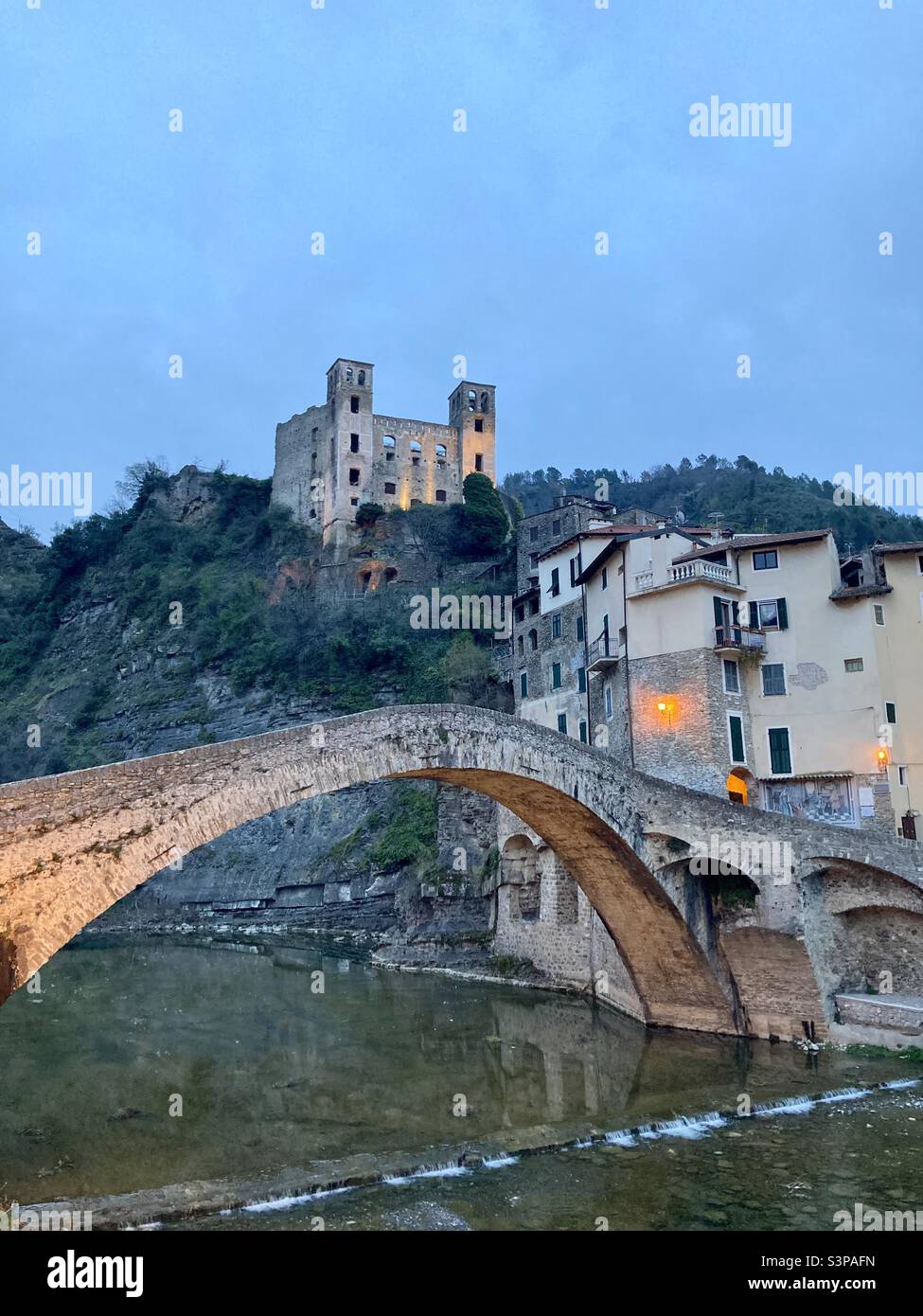 The Ponte Vecchio in Dolceaqcua made famous by a painting of Claude Monet from 1884. The ruins of the Castle of the Doria in the background. - Smartphone Captured Stock Image