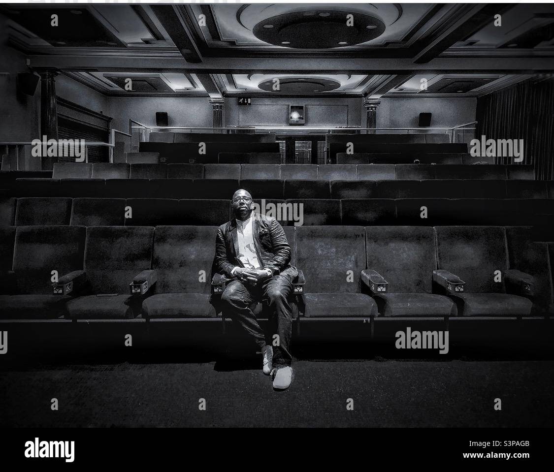 Portrait of a Black male in a disused auditorium. - Smartphone Captured Stock Image