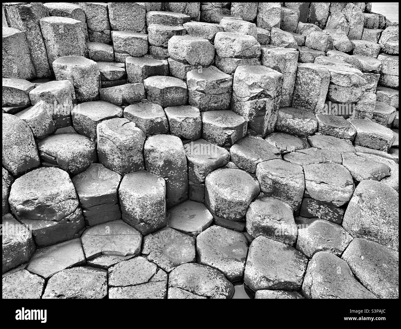The hexagonal shaped volcanic rock columns of Giant’s Causeway are world famous. This spectacular natural wonder is visited by hundreds of thousands of tourists annually. Photo ©️ COLIN HOSKINS. - Smartphone Captured Stock Image