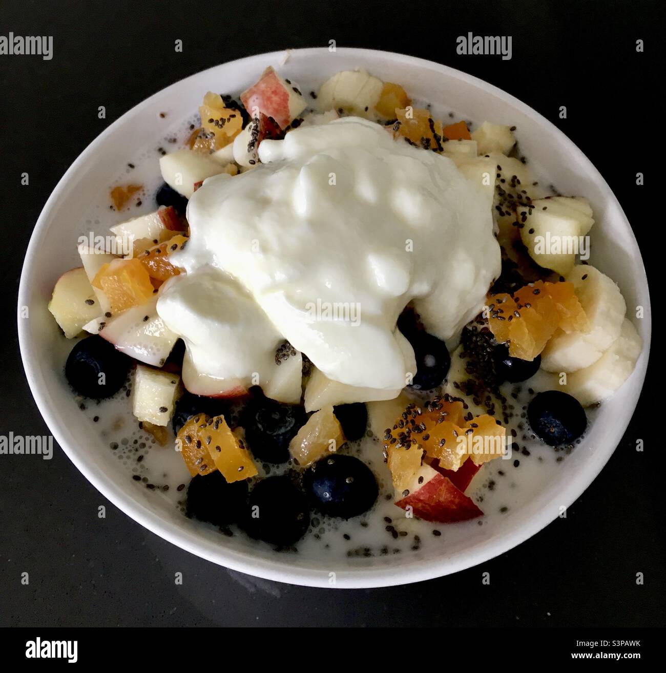 Delicious healthy breakfast bowl of fruit, oats and yoghurt Stock Photo