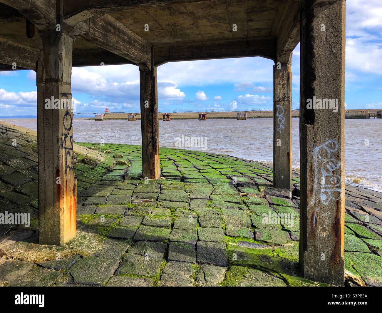 Underneath an abandoned stone pier at the coast - Smartphone Captured Stock Image