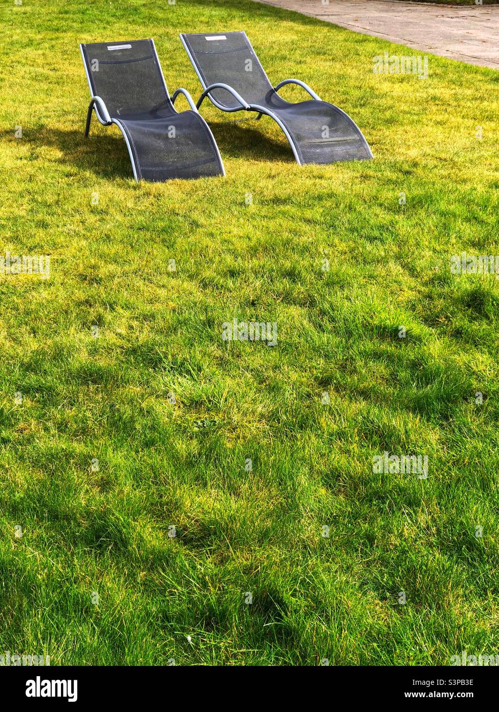 Two sun loungers on the garden lawn - Smartphone Captured Stock Image