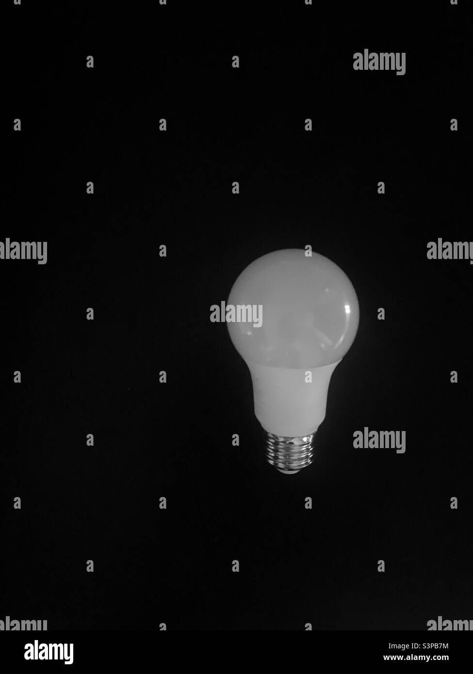 Light bulb on a black background - lightbulb Stock Photo