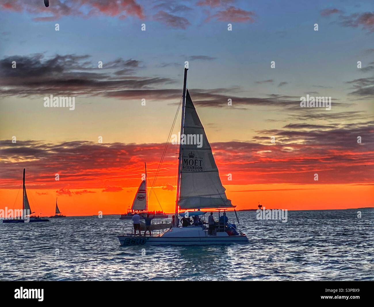Sailboats watching sunset in Key West Florida Stock Photo