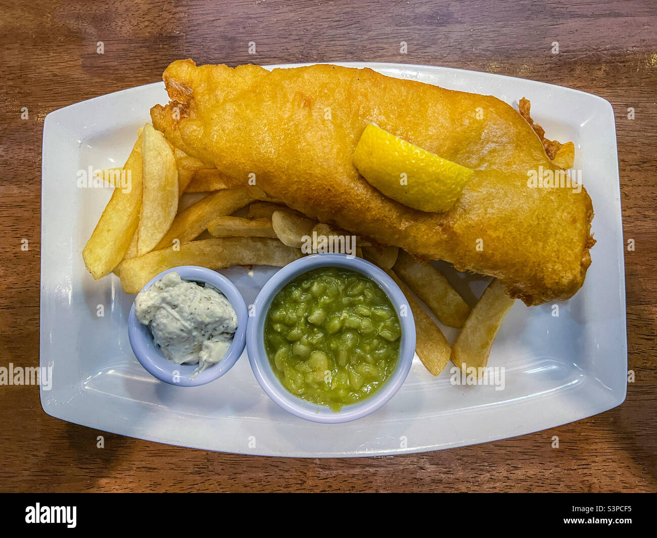 Fish and chips and mushy peas and tartare sauce Stock Photo