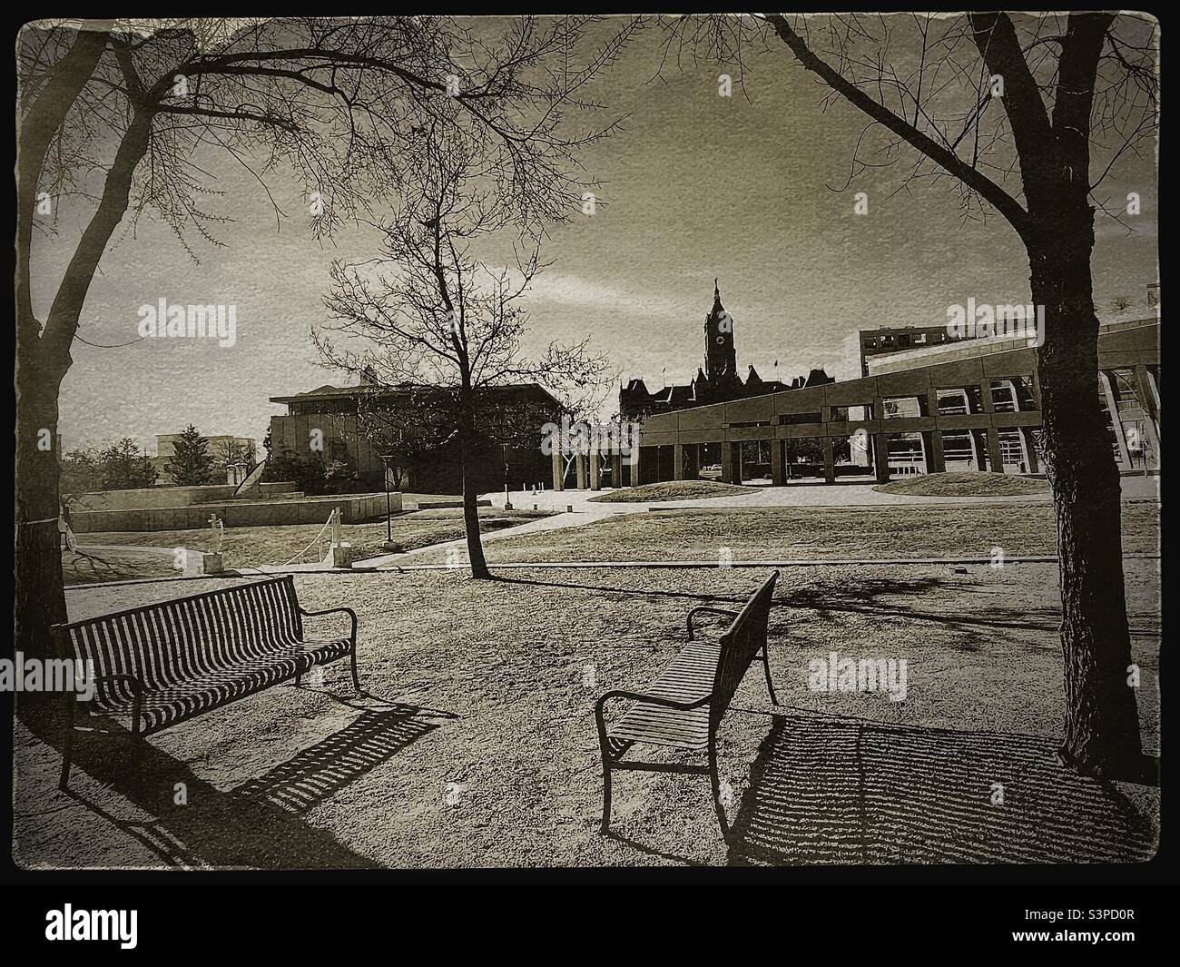 The modern Salt Lake City public library in the foreground, and the older, classical City and County Building in the background, shown in a vintage styling, as seen from a small city park  just east. - Smartphone Captured Stock Image