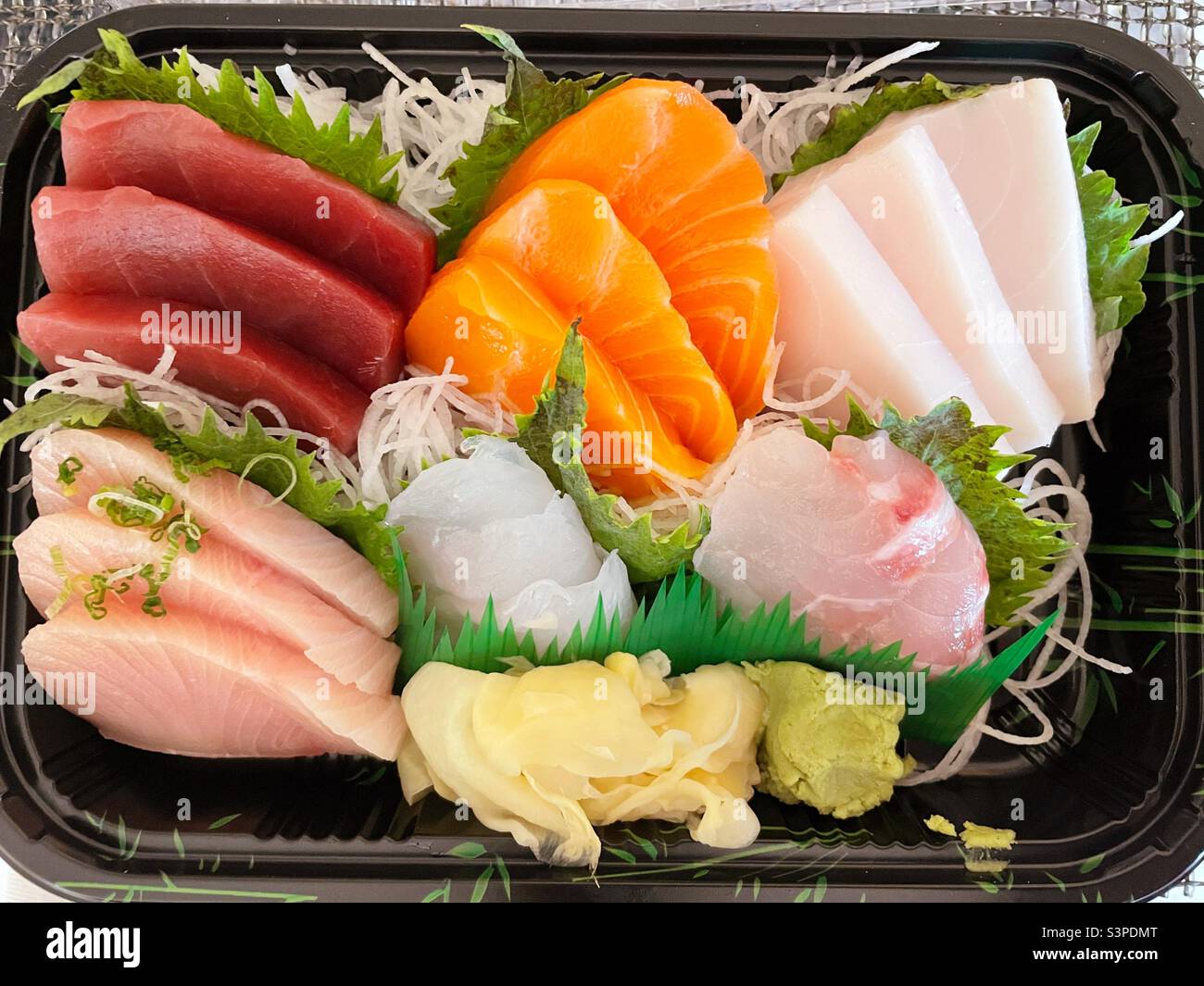 Flat lay of an assorted sashimi meal in a delivery plate, 2022, New York City, United States - Smartphone Captured Stock Image