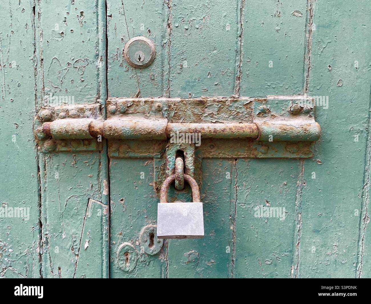 Old rusty bolt on a green painted door Stock Photo Alamy