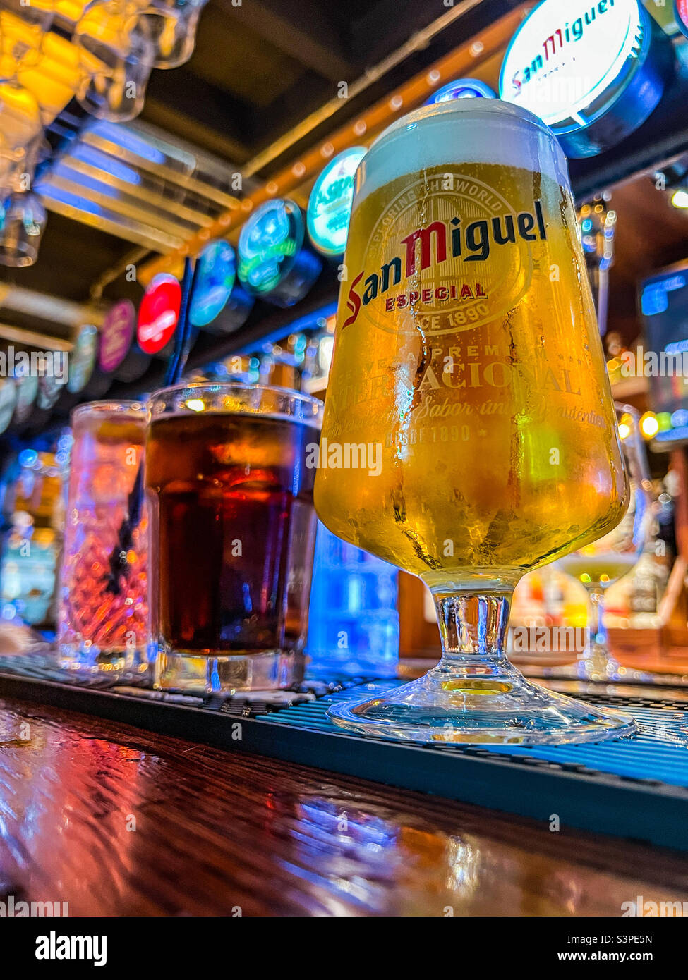 Refreshing lager and cola and cocktail drinks on bar Stock Photo