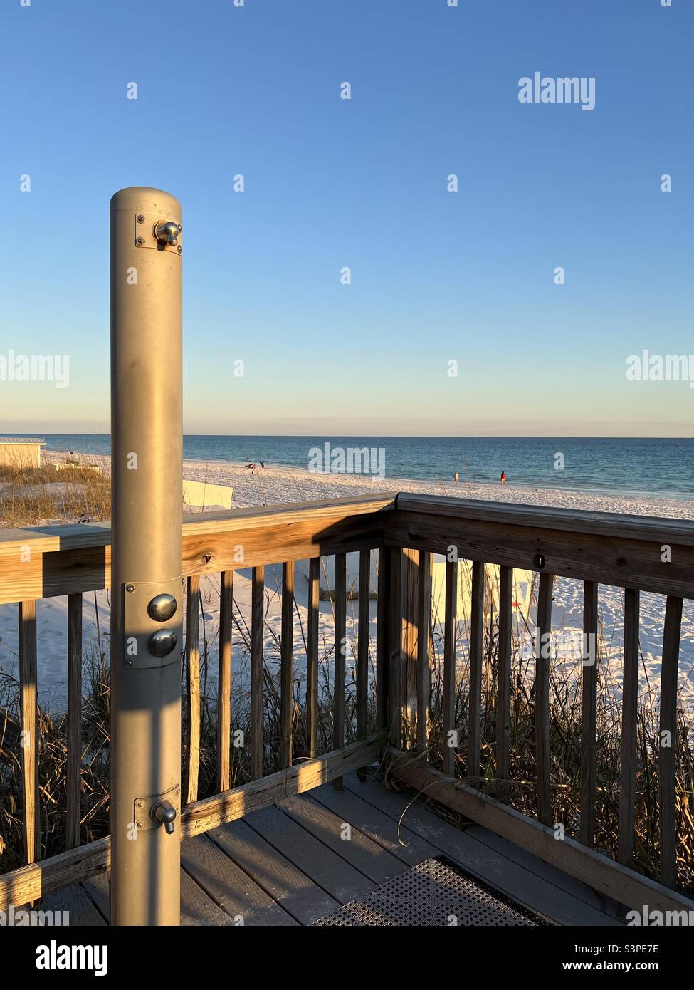 Evening sun glowing on outdoor shower on white sand Florida beach - Smartphone Captured Stock Image