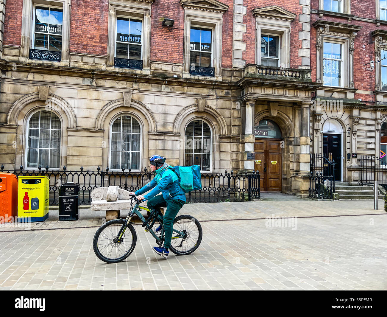 Deliveroo delivery cyclist delivering takeaway food in Leeds city centre Stock Photo