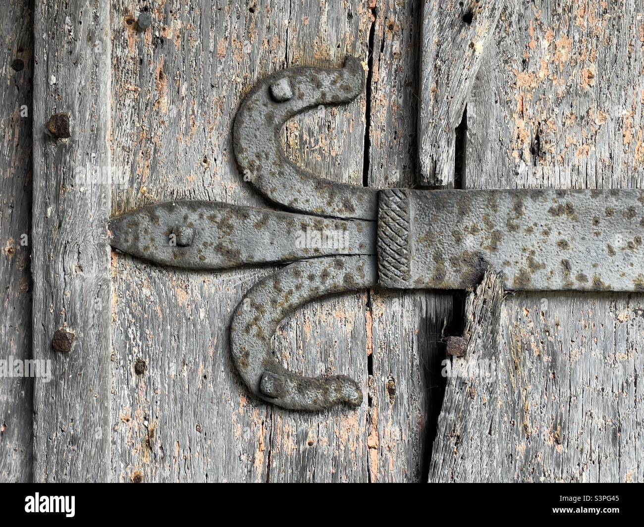 The iron work strap hinge on the door of Cotheridge Parish Church in closeup - Smartphone Captured Stock Image