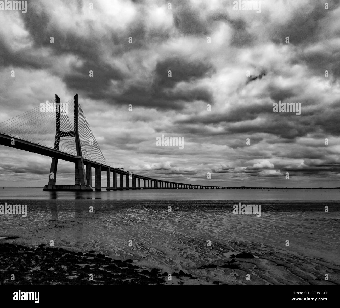 A black and white image of The largest bridge/viaduct in the EU- Ponte Vasco da Gama, Sacavém - Smartphone Captured Stock Image