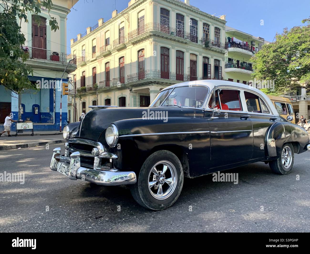 Classic American car in traffic in Havana, Cuba. Transport. Daily life in Havana - Smartphone Captured Stock Image