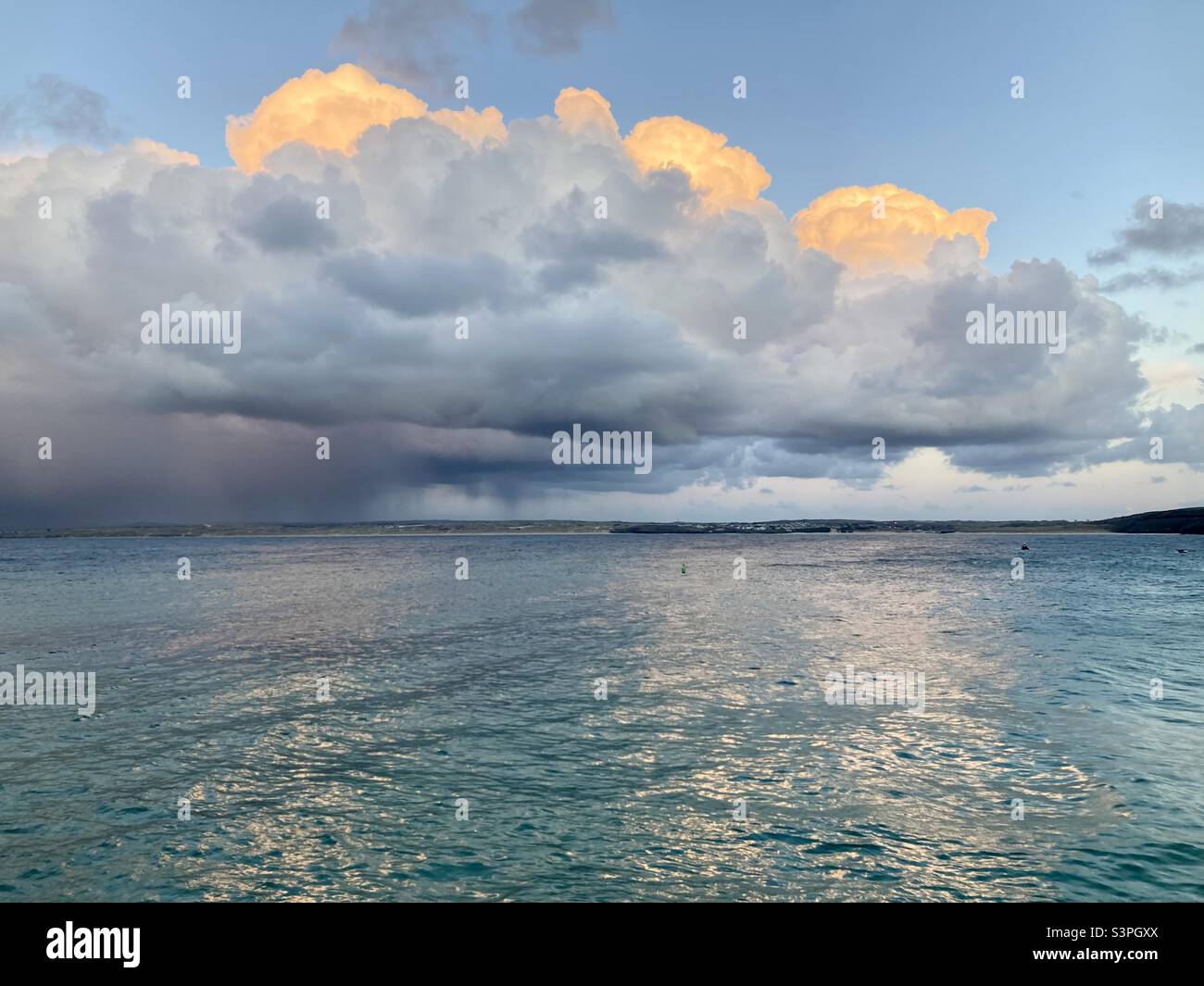 Clouds appear to be on fire over the sea at sunset - Smartphone Captured Stock Image
