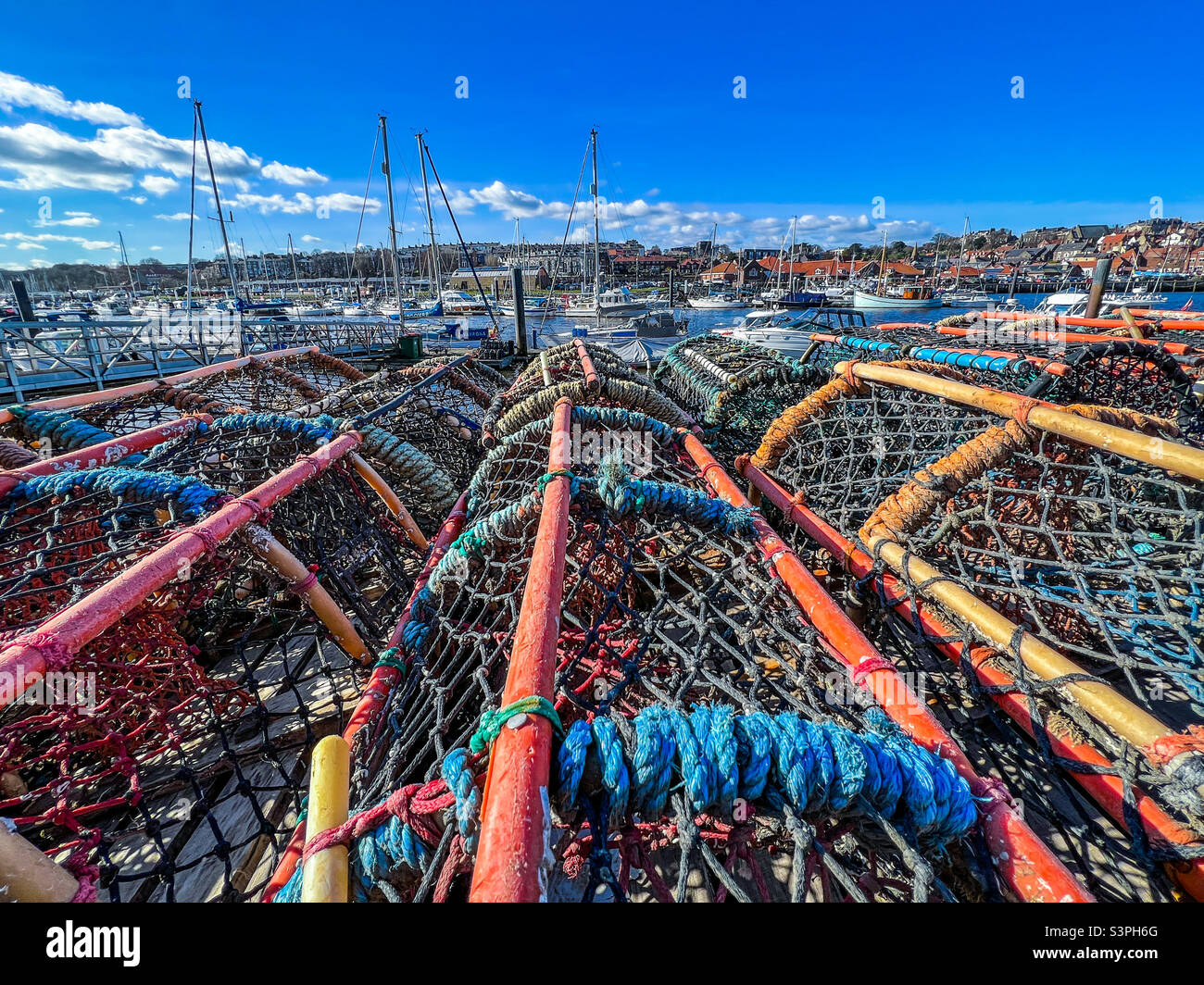 Lobster pots stacked on Whitby quayside on harbour Stock Photo