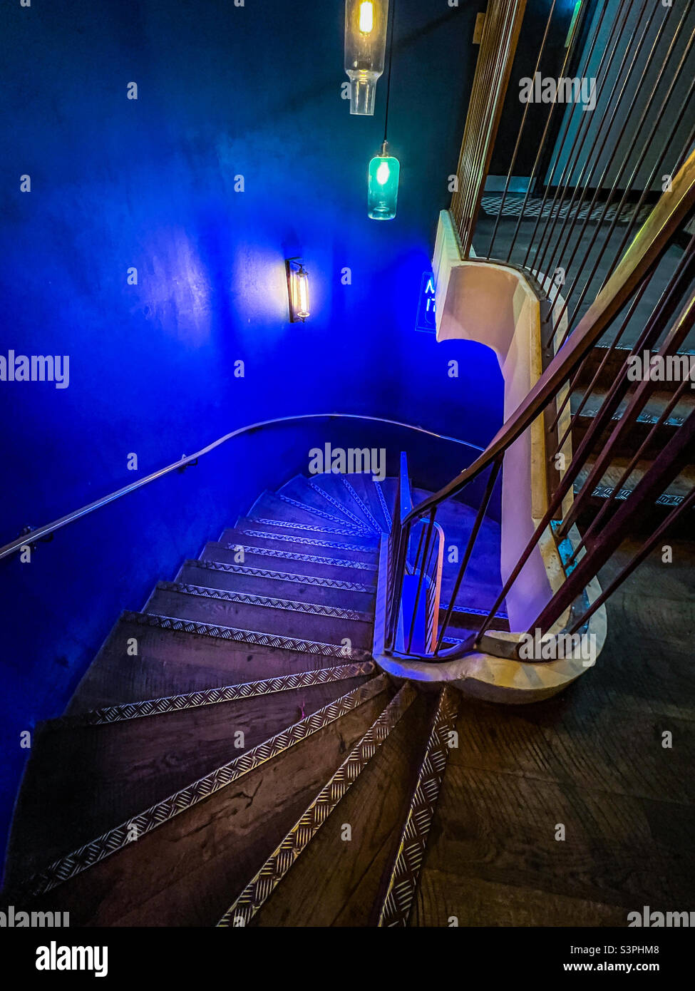 Old wooden staircase with blue led lights Stock Photo