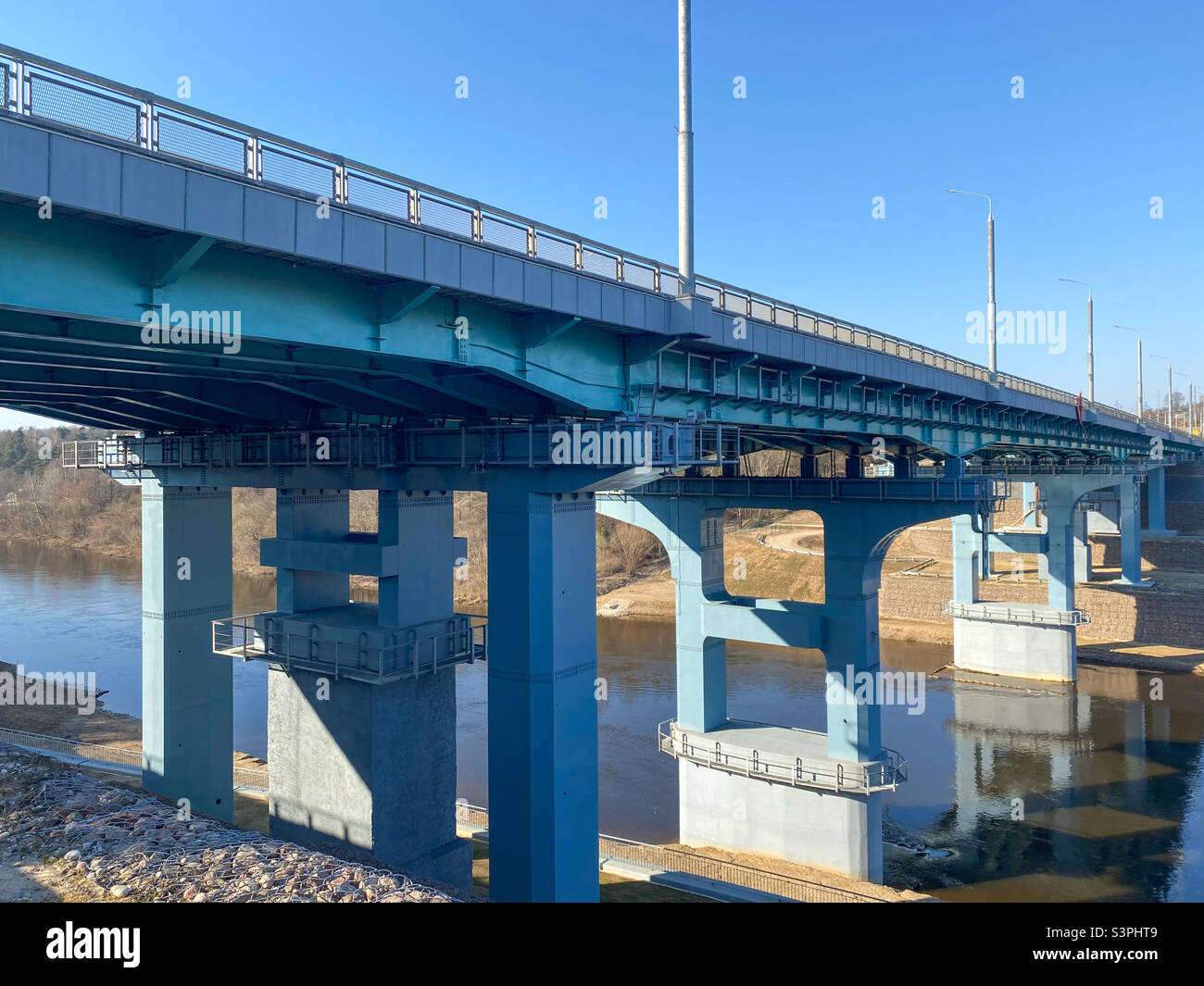 A road bridge over the river. Structures of the automobile bridge from below - Smartphone Captured Stock Image