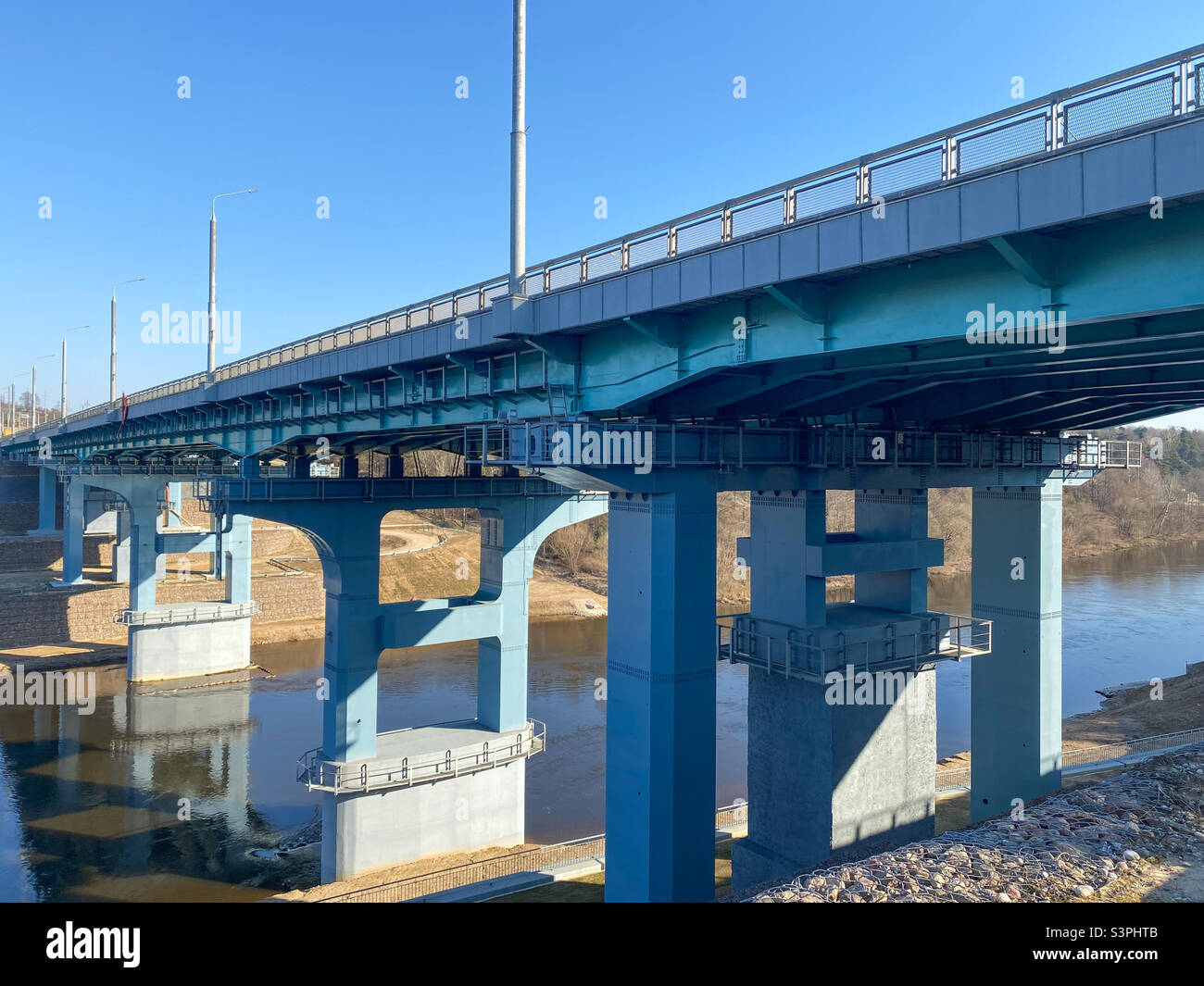 A road bridge over the river. Structures of the automobile bridge from below - Smartphone Captured Stock Image