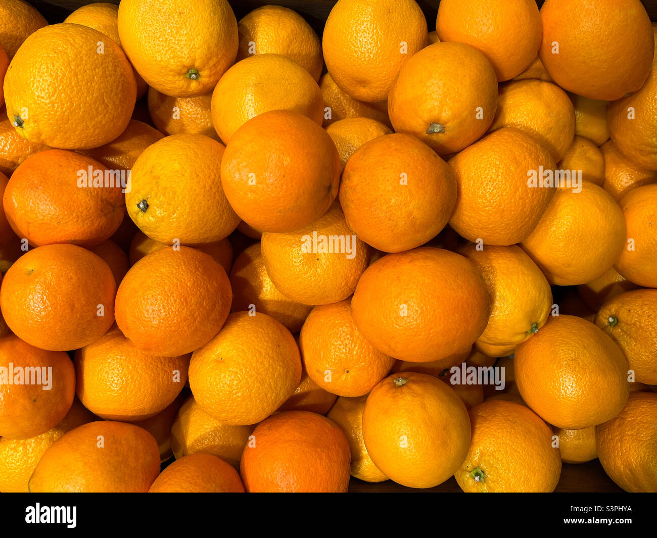 Background of sweet orange oranges or tangerines. Texture of oranges or tangerines. Oranges or tangerines close-up Stock Photo