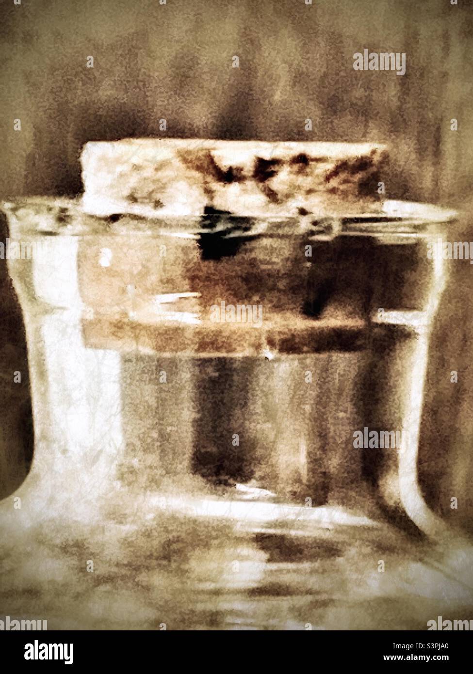 A close up view of the corked end of a miniature ship in a bottle. Grunge and age effects digitally added. - Smartphone Captured Stock Image