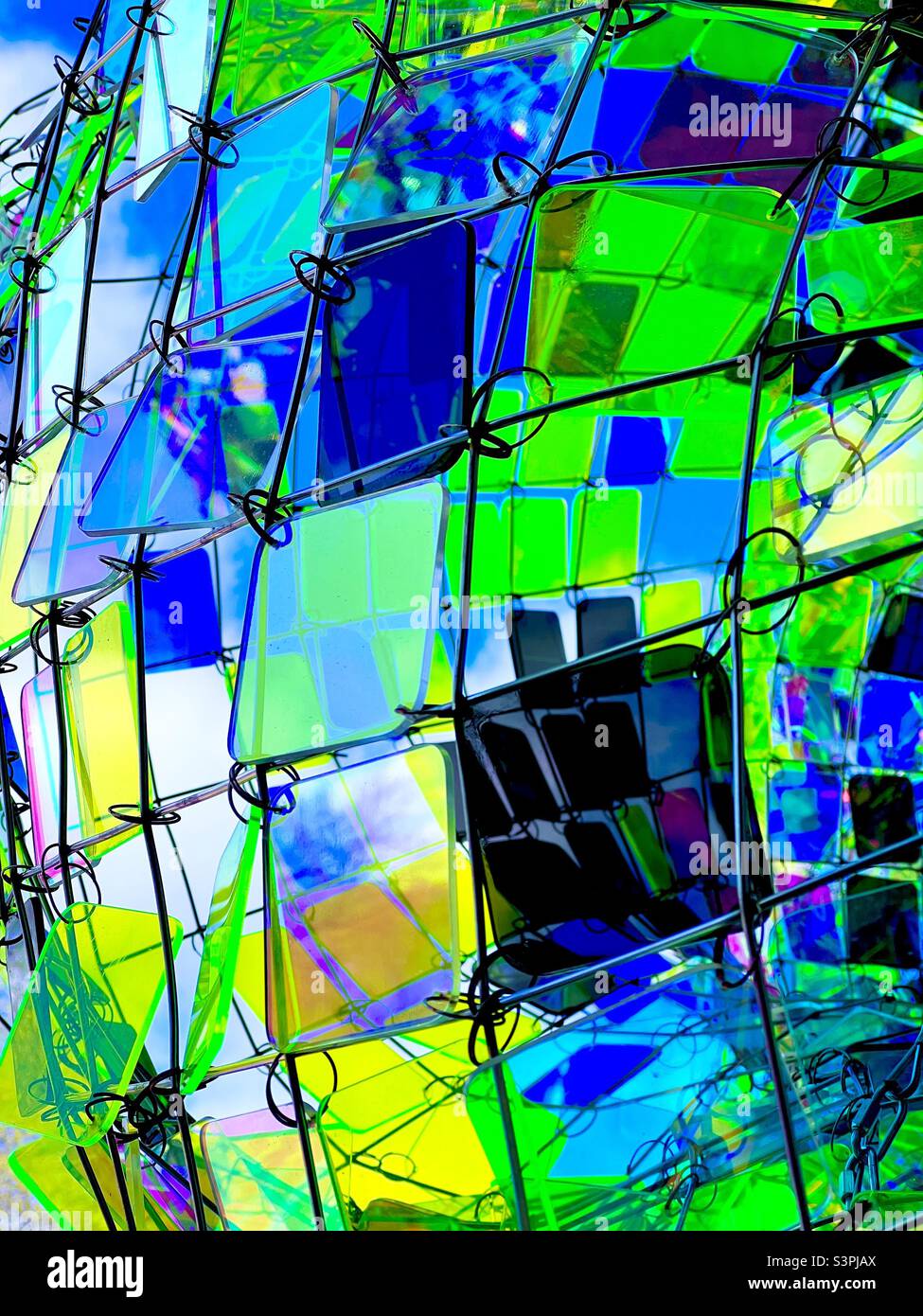 Free form abstract sculpture on colorful reflective glass outside Smithsonian museum Stock Photo