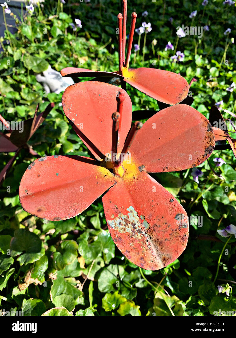 Yard art metal flowers in a spring garden Stock Photo Alamy