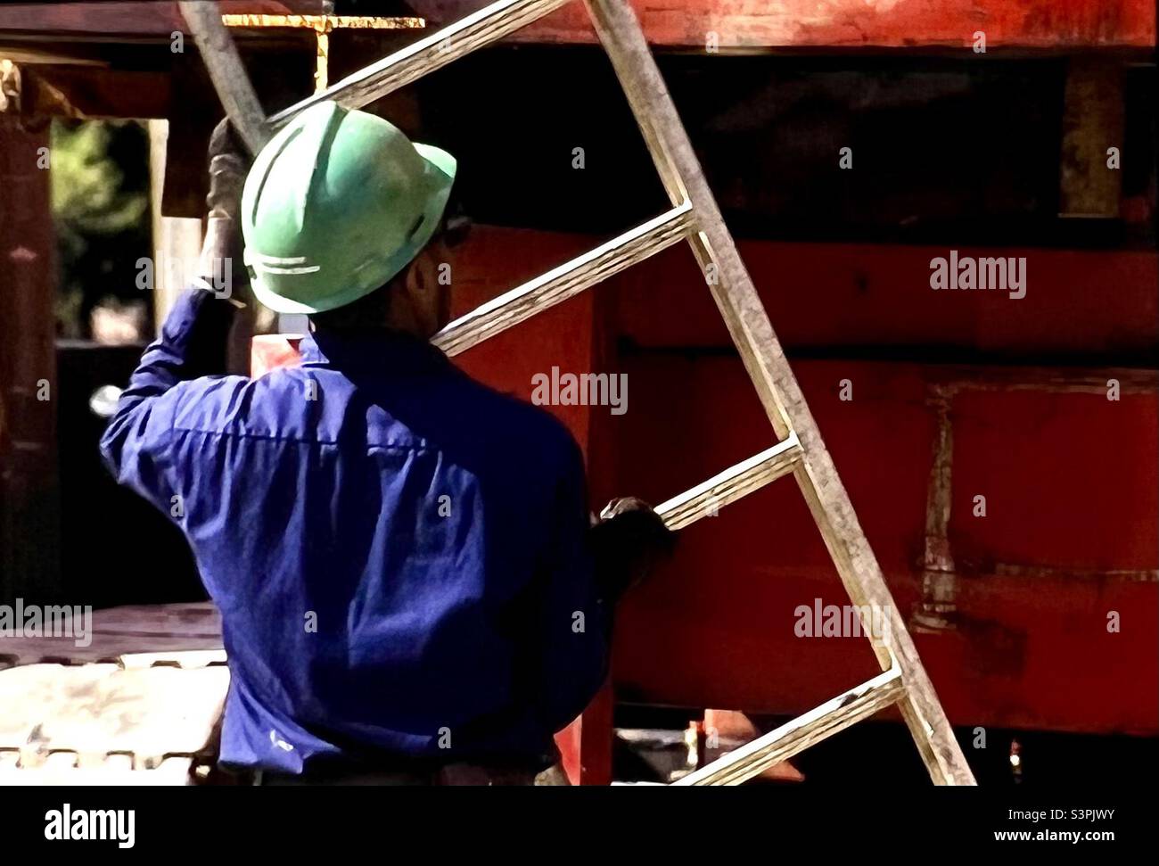 Construction worker with hard hat and ladder - Smartphone Captured Stock Image