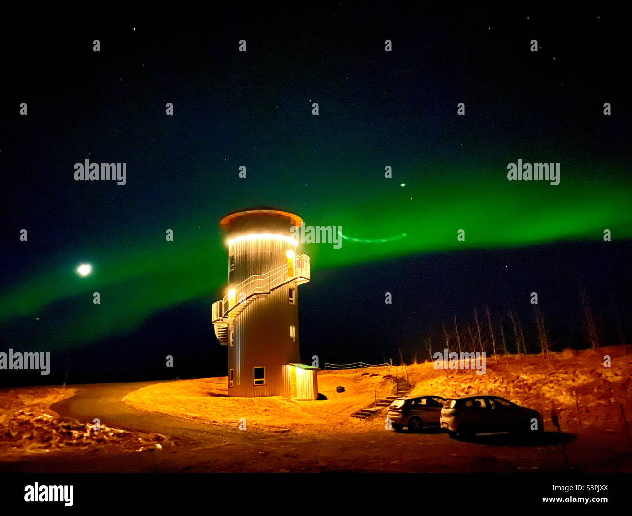 Converted silo lit up against the Northern Lights in Iceland - Smartphone Captured Stock Image