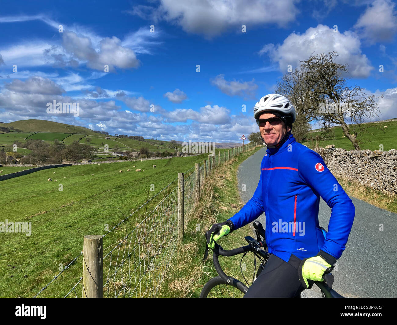 Cyclist wearing a blue jersey in Burnsall North Yorkshire Stock Photo