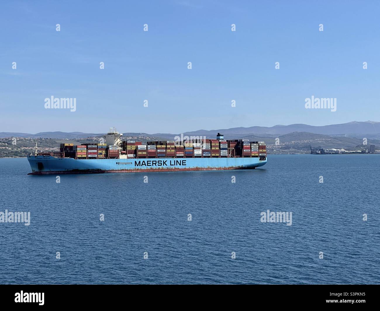 Big loaded Maersk container vessel anchored on the anchorage in front