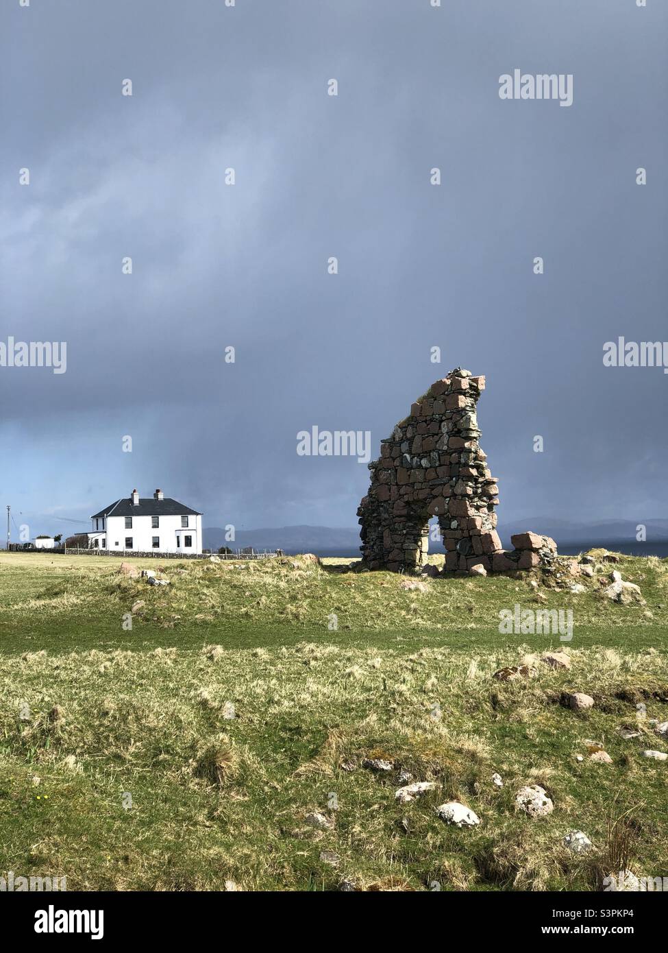 White House and ruin under a brooding sky, Isle of Iona, Scotland - Smartphone Captured Stock Image