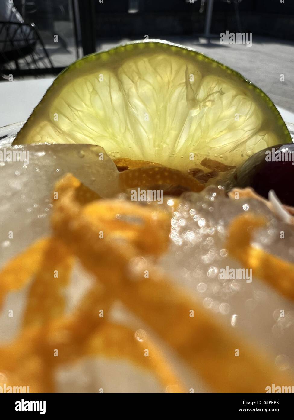 Lime and Orange peel garnish on ice Stock Photo