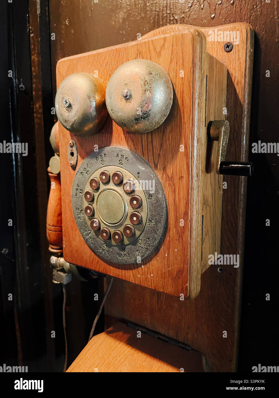 Vintage Wall mounted wooden telephone with exterior ringers and push button dial, USA, 2022 Stock Photo