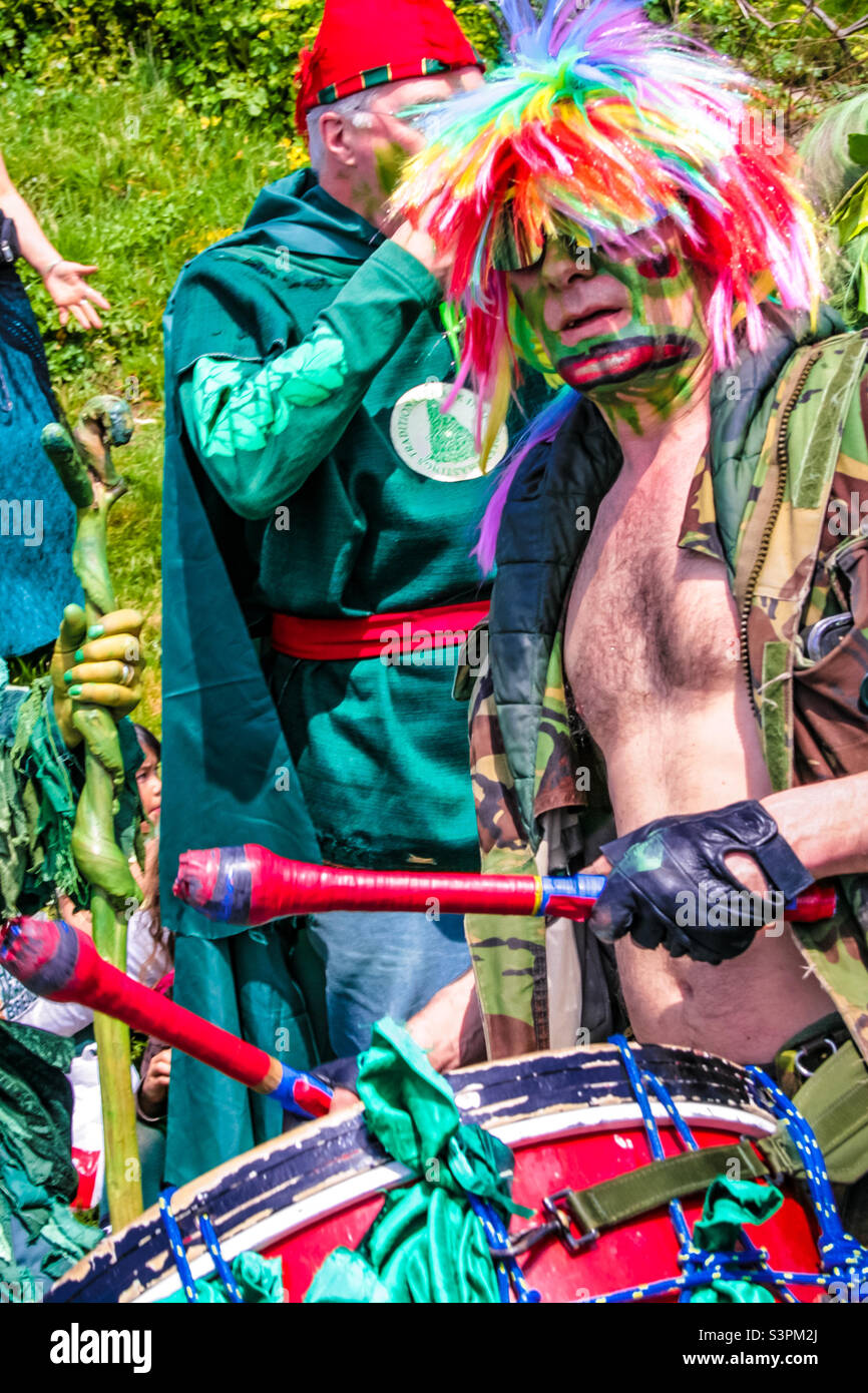 A man dressed in colourful attire is drumming at Traditional Hastings Jack in the Green festivities. UK,May 2008 Stock Photo