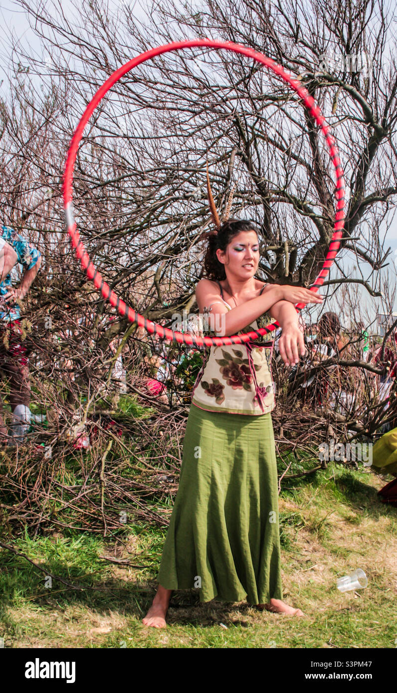 A barefoot woman dressed in green performs with a hoop at Traditional Hastings Jack in the Green festivities. UK, May 2008 - Smartphone Captured Stock Image