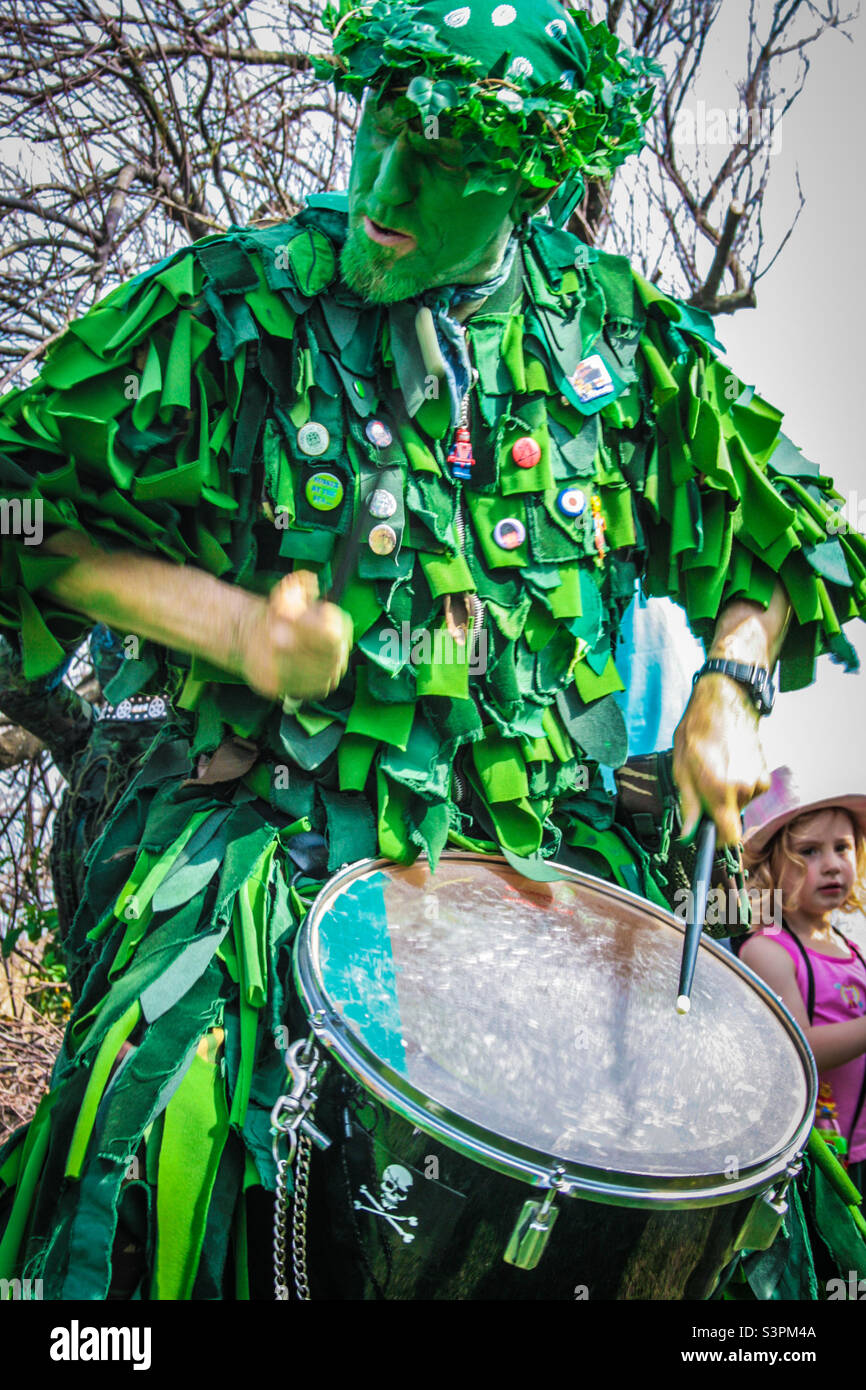A “bogey” dressed in green drums enthusiastically at Traditional Hastings Jack in the Green festivities. UK, May 2008 Stock Photo