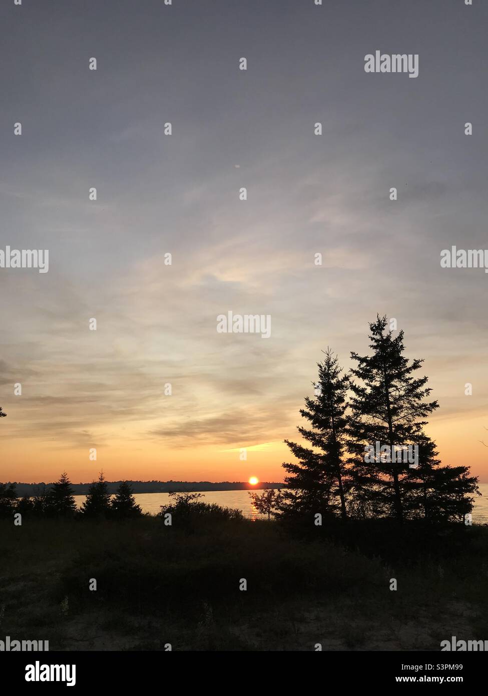 Wilderness sunset over Lake Michigan Stock Photo Alamy
