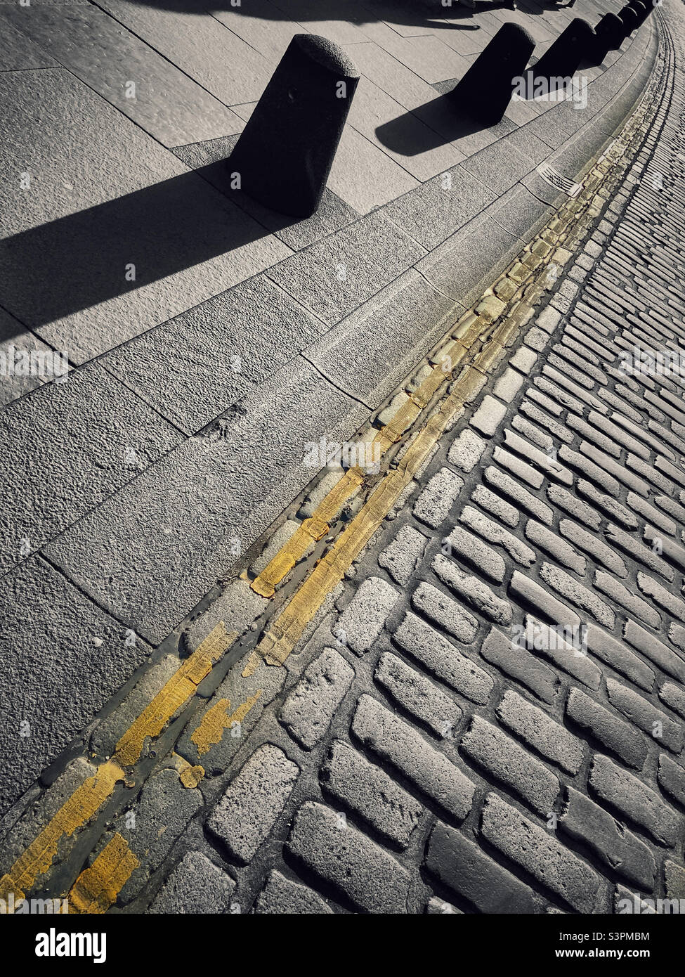 Cobblestones and double yellow lines abstract Stock Photo