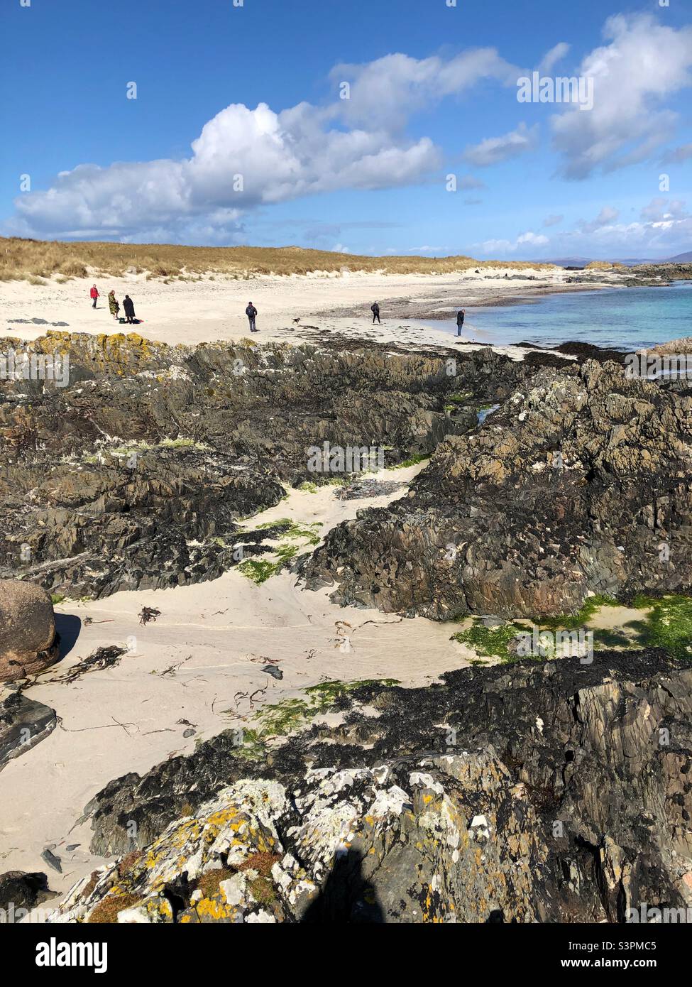 People on the beach, Isle of Iona, Scotland - Smartphone Captured Stock Image