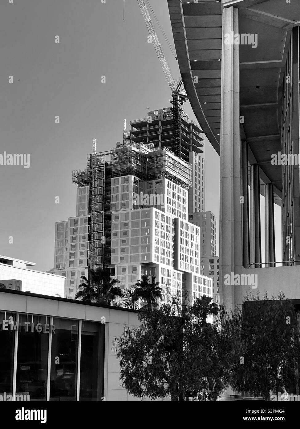 LOS ANGELES, CA, MAR 2021: construction work on Frank Gehry's new architectural project in Downtown with edge of Dorothy Chandler Pavilion in foreground. Black and white - Smartphone Captured Stock Image