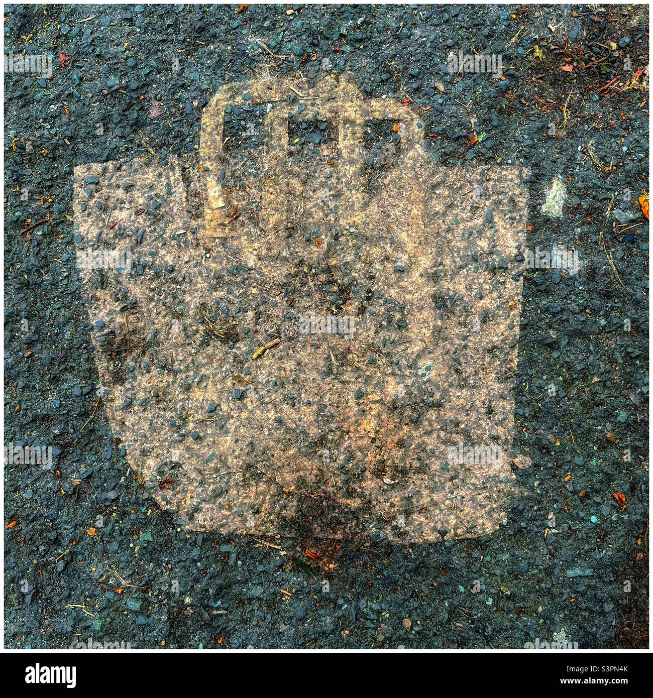 Paper grocery bag ground into the asphalt - Smartphone Captured Stock Image