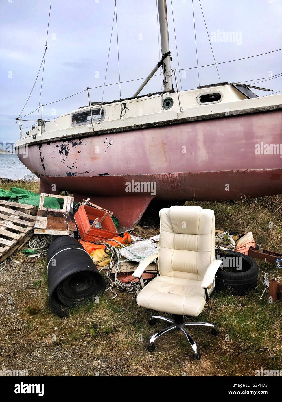 Ruined boat and assorted trash at Craignure, Isle of Mull, Scotland - Smartphone Captured Stock Image