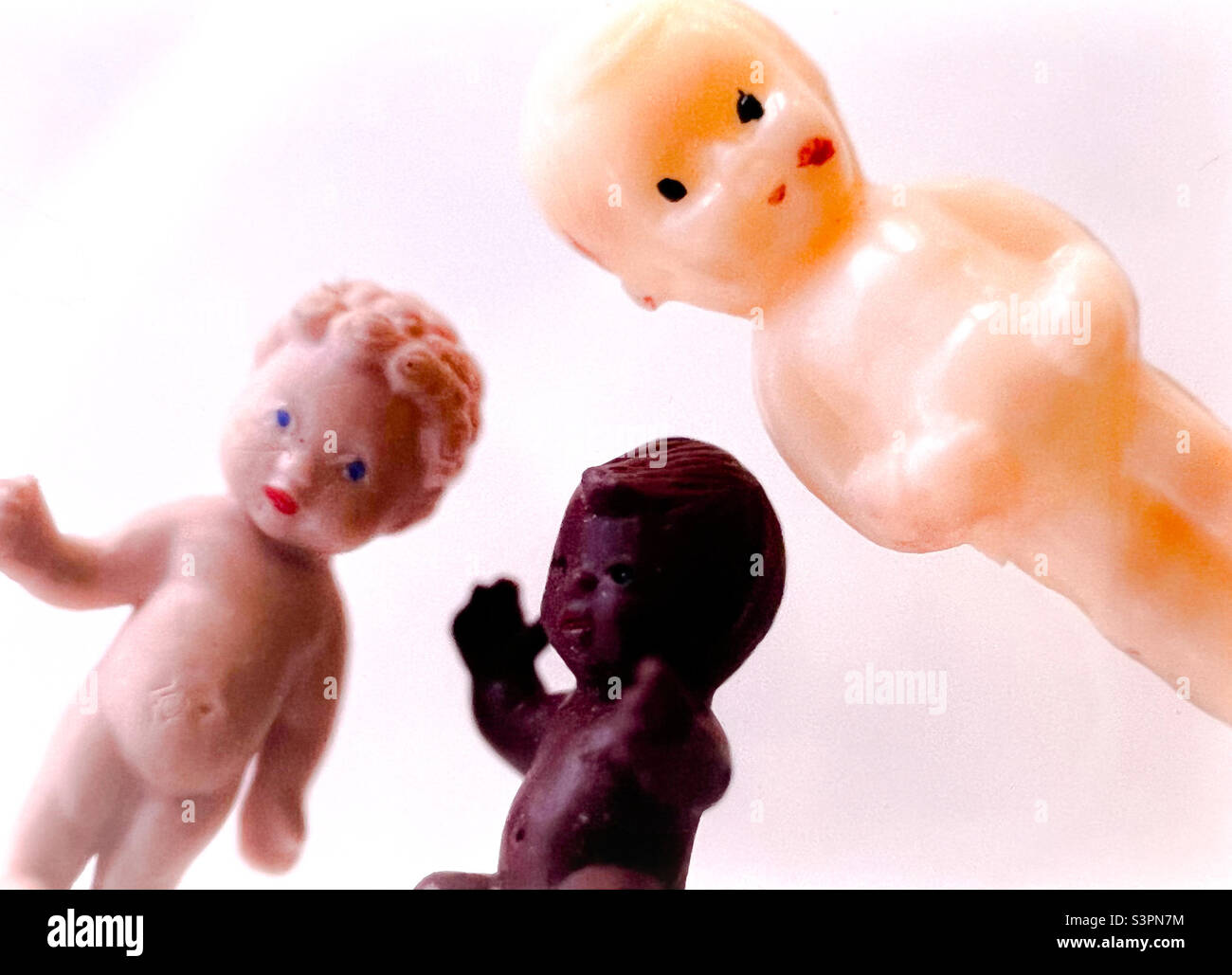 Trio of Vintage toy kewpie dolls Caucasian and African and blonde Stock Photo