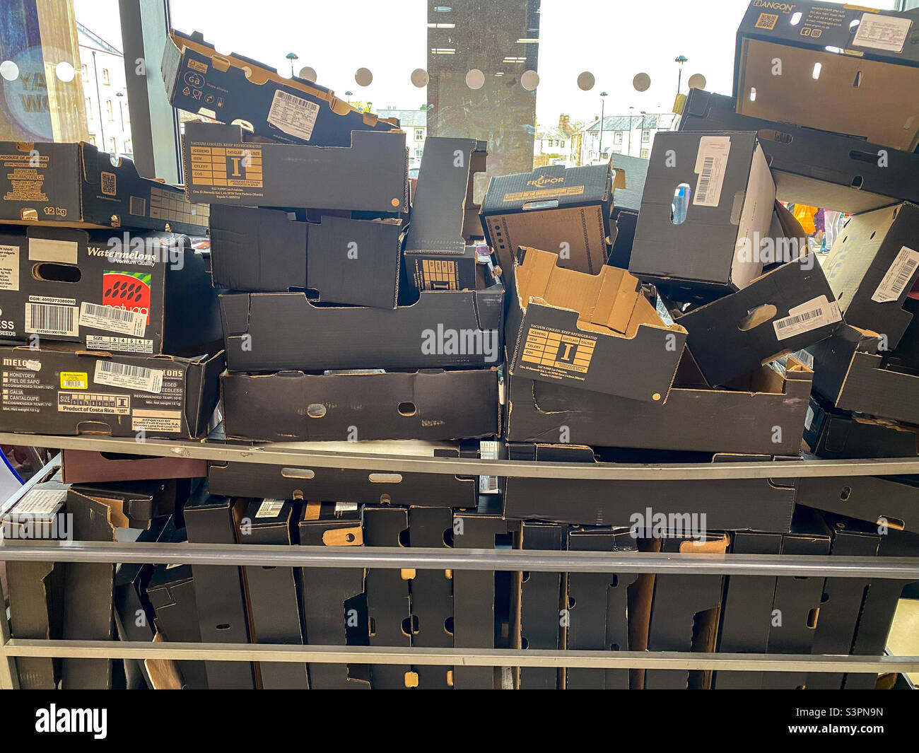 Waste cardboard boxes piled up at a supermarket. - Smartphone Captured Stock Image