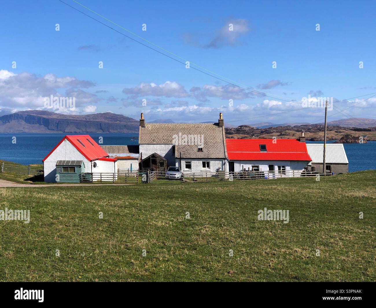 Bright red roof on farm buildings, Isle of Iona, Scotland - Smartphone Captured Stock Image